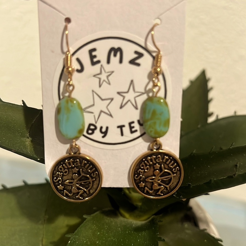 Handmade gold Sagittarius sign earrings with turquoise colored accent stones
